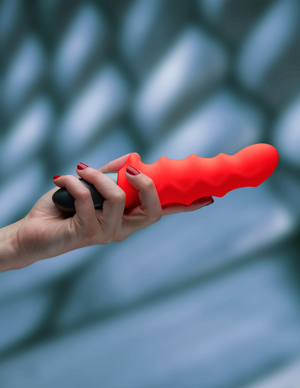 Stronic Surf Vibrator by Fun Factory orange in hand